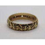 A 9ct gold eternity ring having heality carved pattern studded with white stones, size L, 2.2g.