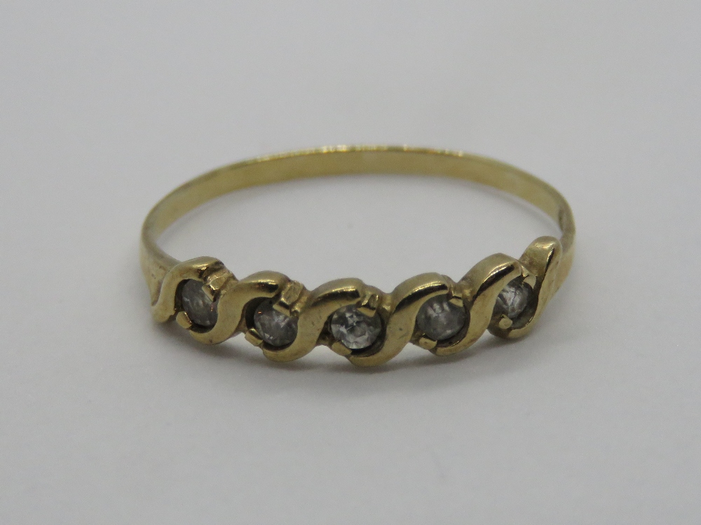 A 9ct gold ring having five white stones in wave setting, hallmarked, size N, 1g.