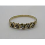 A 9ct gold ring having five white stones in wave setting, hallmarked, size N, 1g.