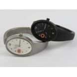Two stainless Superdry watches; one in black having black dial with date aperture,
