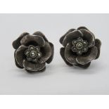 A pair of silver and marcasite floral stud earrings, each stamped 925 and measuring 17mm dia.