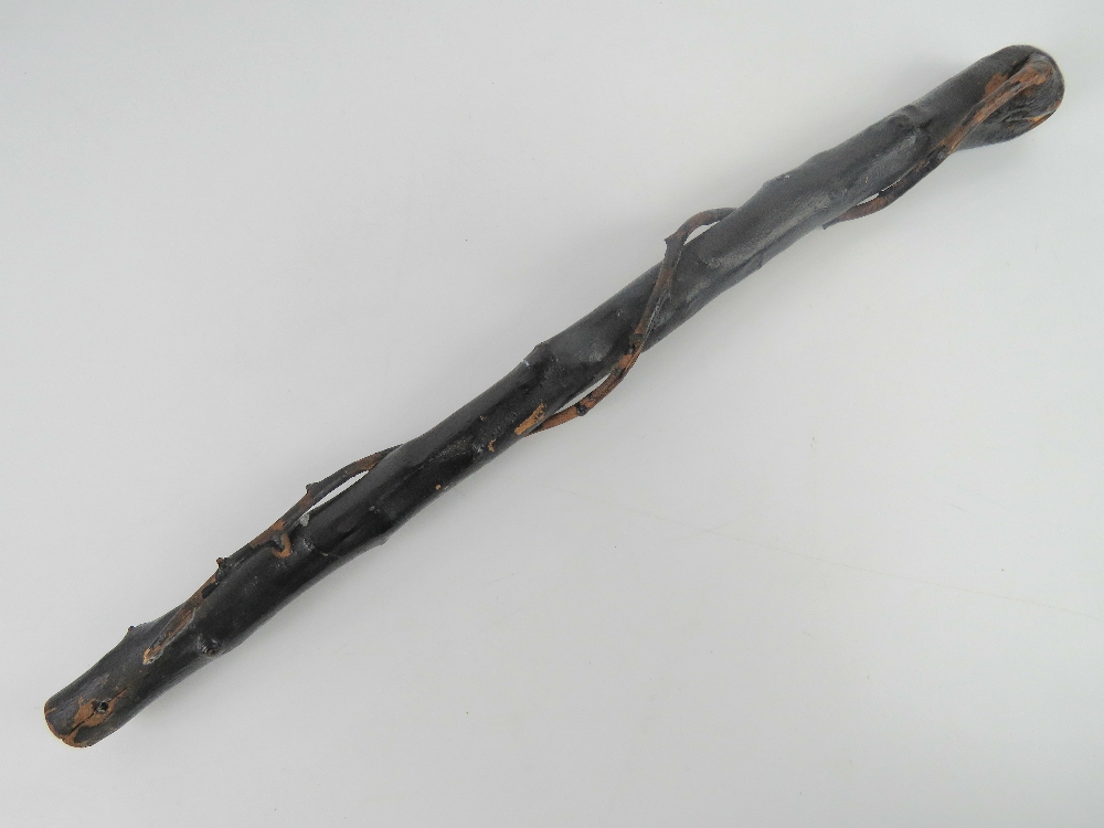 An Irish black painted natural wood knobkery. 58cm in length.