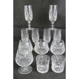 A set of four cut glass brandy balloons, together with a set of six cut glass champagne flutes,