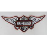A contemporary cast metal Harley Davidson sign.
