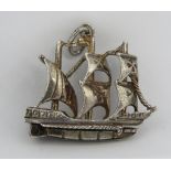 An unusual charm or pendant in the form of a three masted ship bearing Maltese Cross upon the sails,