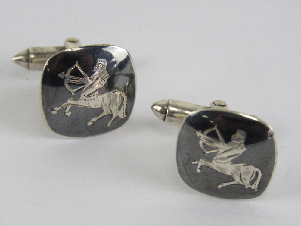 A pair of sterling silver niello cuff links having sagittarious centre with bow and arrow design.