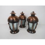 A set of three copper coloured lanterns, each standing 22cm high inc hanging loop.