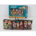 A set of Seven Dwarves figurines from Disney's Snow White in original packaging,