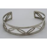 A HM silver bangle having open leaf pattern, 15mm wide, hallmarked 925 and further stamped 925.