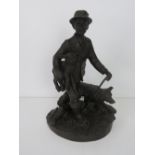 A heredites bronzed figurine of a shepherd and dog.
