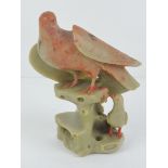 An Oriental soapstone dove figurine standing 13cm high.