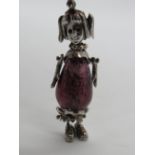 An articulated silver pendant in the form of a girl having glass bead body, stamped 925, 45mm.