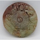 An unusual two colour carved jade disc pendant having phoenix and dragon design upon,