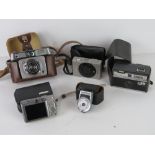 Camera equipment; a Yashica Yem35 Super lightmeter, a Kodak Instamatic 50, two Canon cameras,