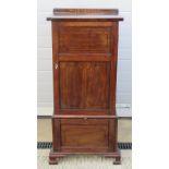 An Edwardian gramophone and music cabinet having twin slide shelves with fall front compartment