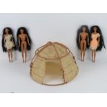 Four Pocahontas dolls made by Mattel, two with dresses, together with hut.