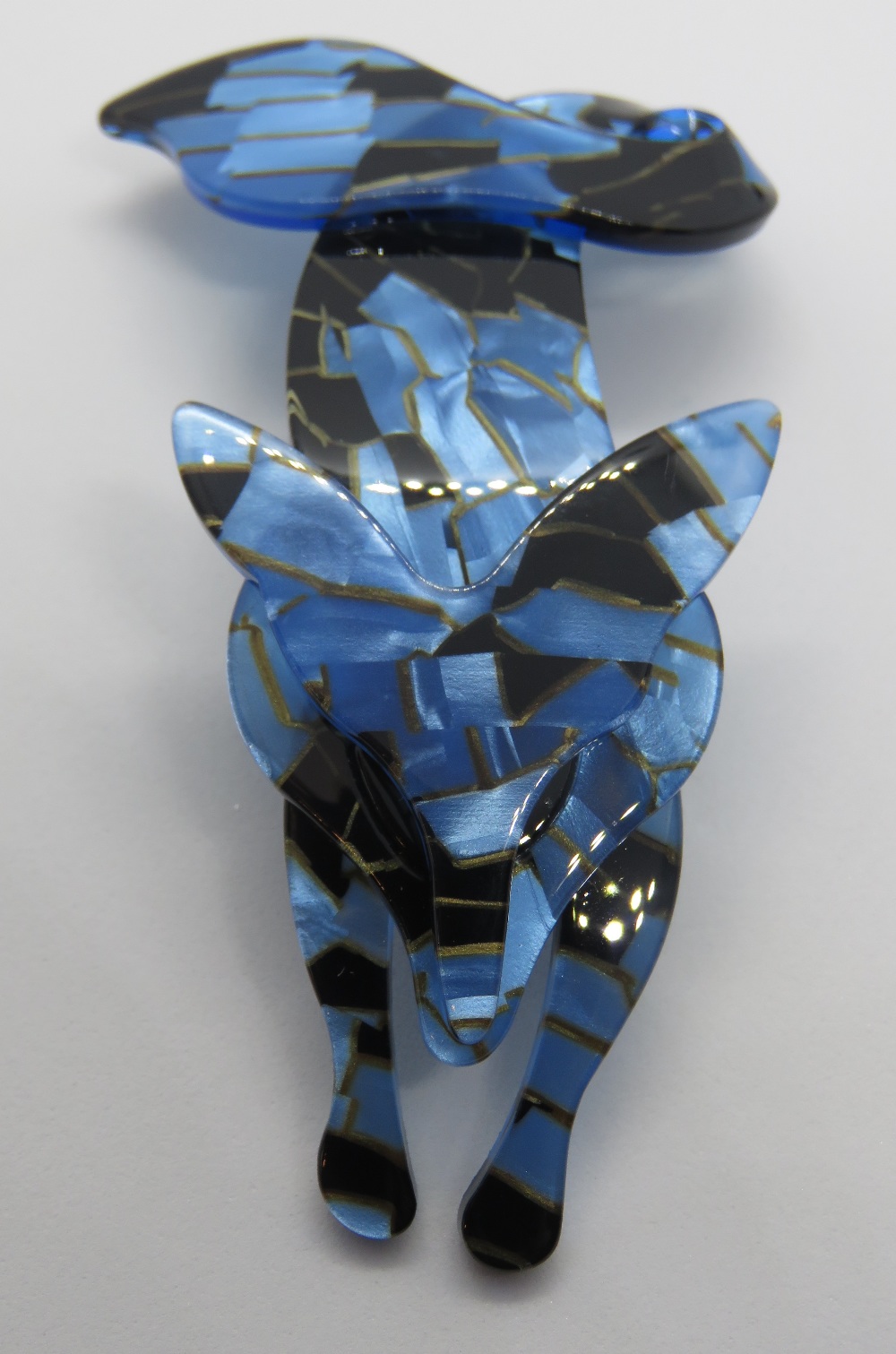 An overlaid plastic brooch in the style of Lea Stein in the form of a fox, 7.5cm in length.