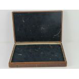 A vintage wooden display box opening to reveal padded fabric lining within, 44 x 29.5 x 7cm.