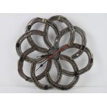 A wall clock formed from eight horseshoes and having central quartz movement, slightly a/f,