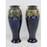 A pair of Royal Doulton Lambeth vases in green and blue with floral urns,