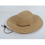 A handmade raffia straw hat made by Scala, size S/M.