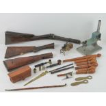 A quantity of assorted militaria items inc, rifle stocks, loader press, gauge kits, ammo case,