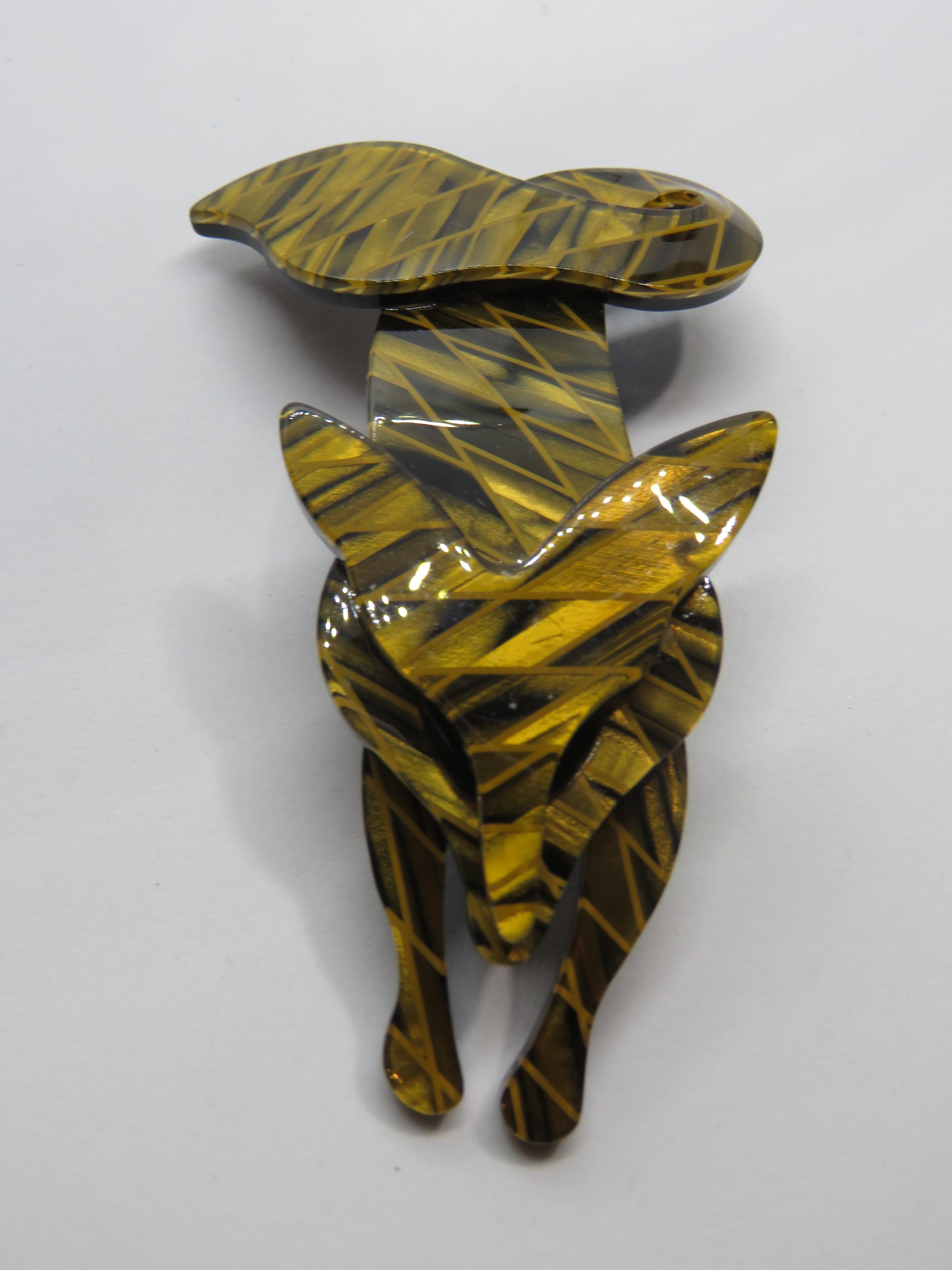 An overlaid plastic brooch in the style of Lea Stein in the form of a fox, 7cm in length.