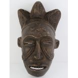 An African carved wooden wall mask, 36cm