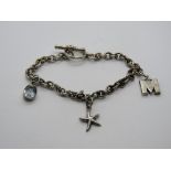 A silver charm bracelet having 925 aquam