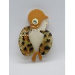 An overlaid plastic brooch in the style of Lea Stein in the form of a 1930s woman in hat and