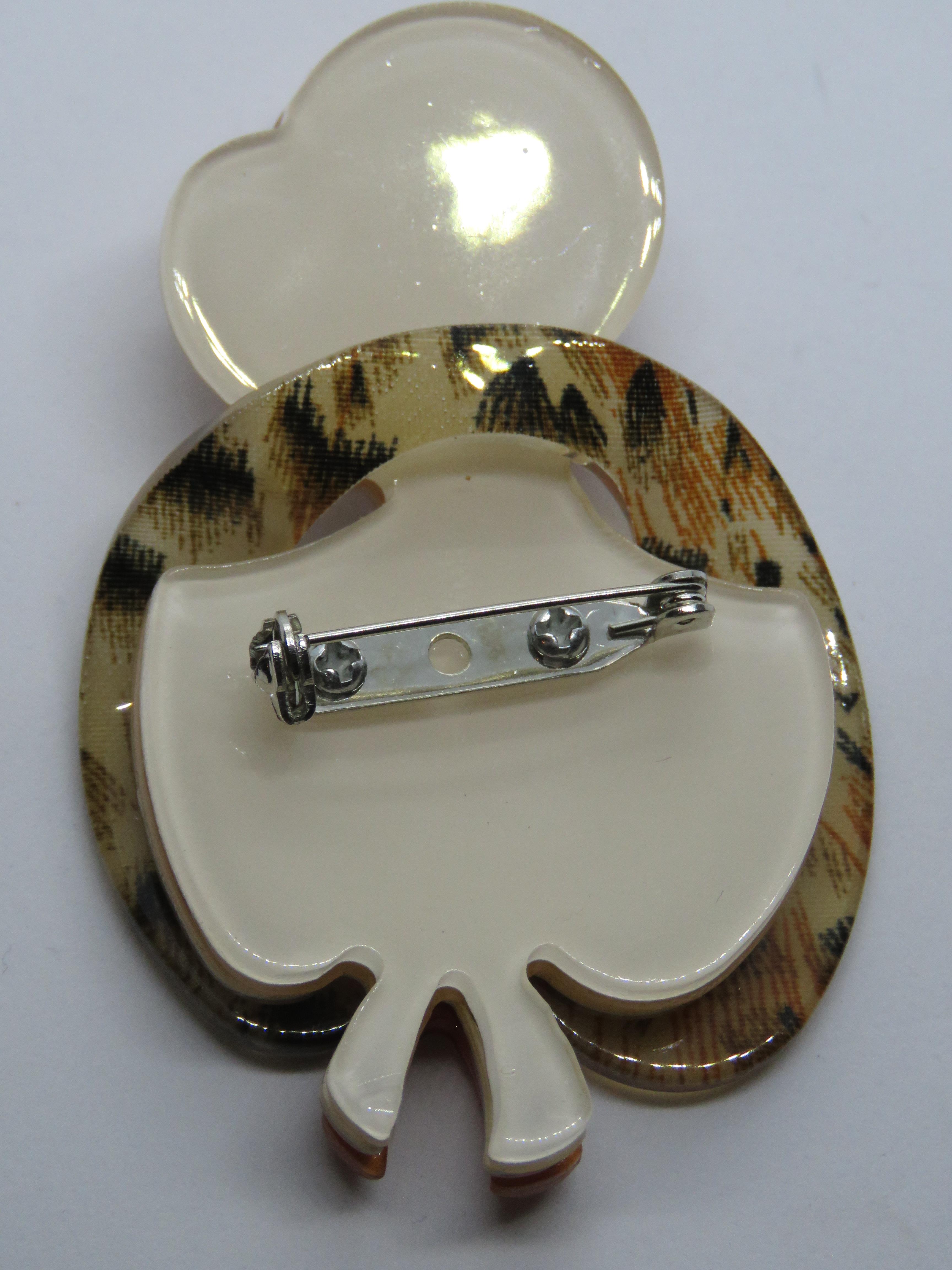 An overlaid plastic brooch in the style of Lea Stein in the form of a 1930s woman in hat and - Image 2 of 2