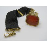 A Georgian gentlemans carnelian seal on waistcoat hanger, carnelian a/f having cared hunting dog,