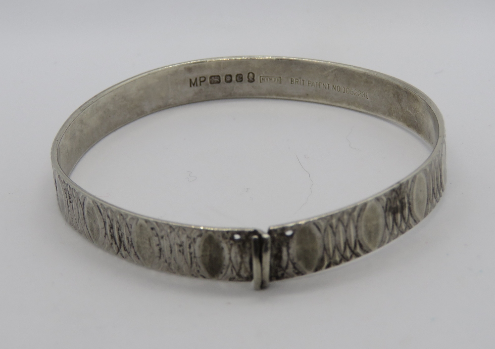 A HM silver bangle having overlapping ov