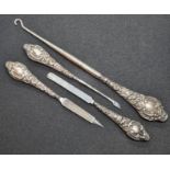 A set of three HM silver handled manicure tools together with a similar HM silver handles button