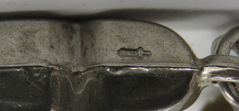 A silver charm in the form of a pair of - Image 2 of 2