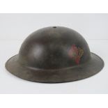A reproduction WWII British helmet havin