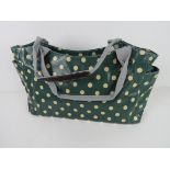 A green polka dot pattern handbag 'as new', approx 39 x 26cm.