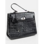 A black faux crocodile skin handbag having single top loop 26 x 23cm.