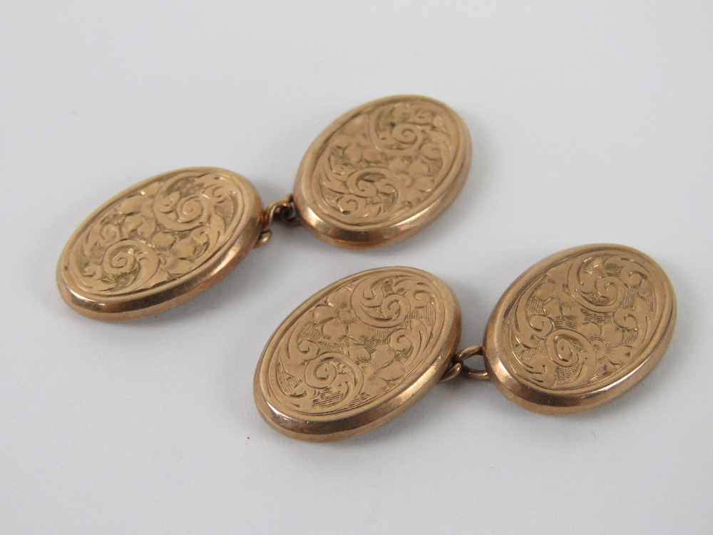 A delightful pair of 9ct rose gold cufflicks having floral engraving throughout, hallmarked 375, 4g.