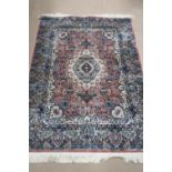 A silk pink and blue ground rug having geometric design, 180 x 126cm.