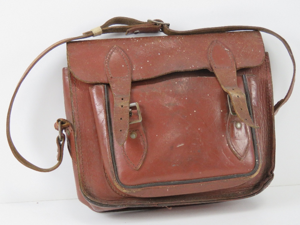 A pigskin leather cartridge bag with strap.