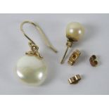 Two single pearl and gold earrings and three gold butterfly backs.