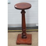 A turned mahogany torchere stand raised over square shaped base, 77cm high.