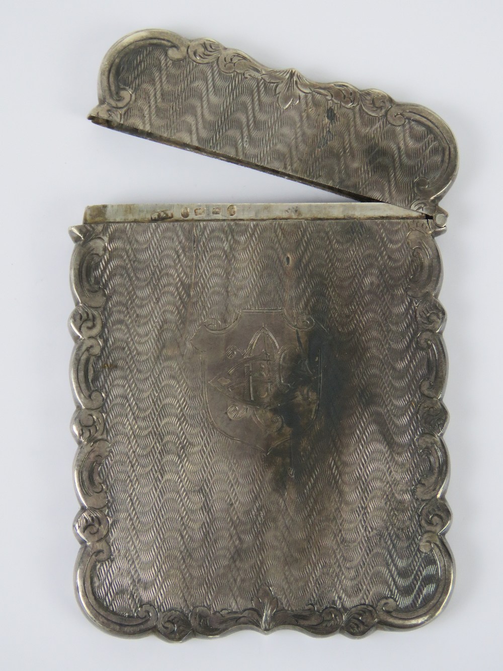 A Victorian HM silver card case having scrolling engraved border and monogrammed shield to front, 9.