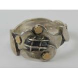 A HM silver Arts and Crafts style ring of abstract floral form.