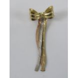 A 9ct gold brooch in the form of a bow, hallmarked 375, 4cm in length, 1.4g.