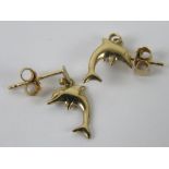 A 9ct gold pair of stud errings having dolphins upon.