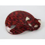 An overlaid plastic brooch in the style of Lea Stein in the form of a sleeping cat, 6cm wide.