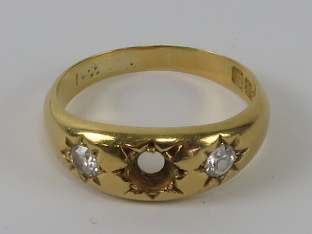 An 18ct gold 'gypsy' style ring having diamonds in star settings, central stone deficient,