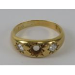 An 18ct gold 'gypsy' style ring having diamonds in star settings, central stone deficient,